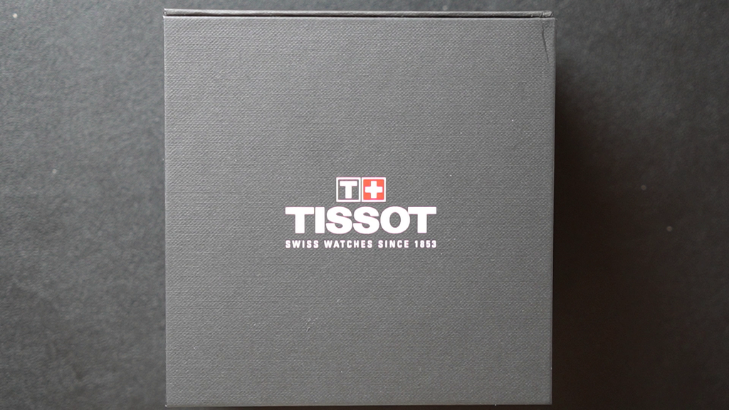 Tissot watch box with brand logo on a dark background