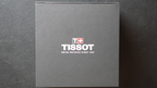 Tissot watch box with brand logo on a dark background
