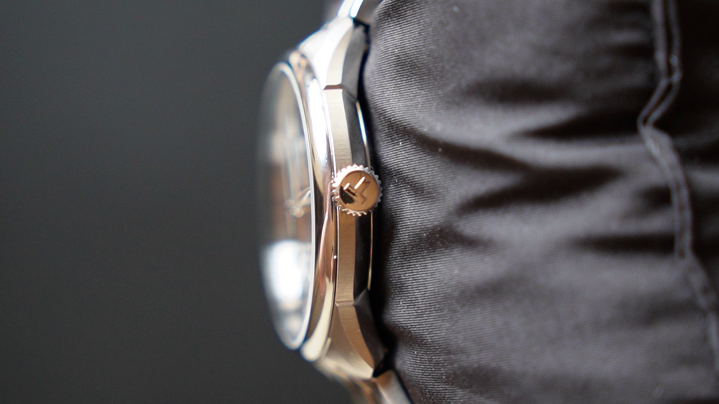Close-up of a silver watch on a dark background