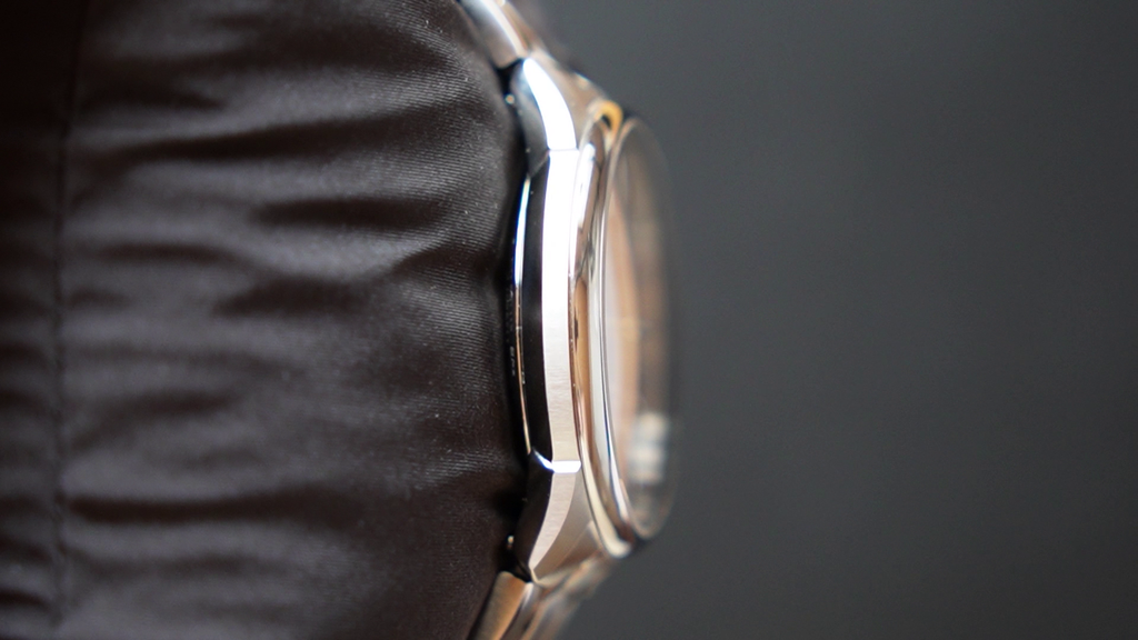 Close-up of a watch with a dark strap on a dark background